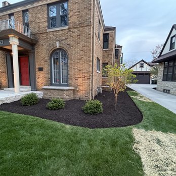 Fresh mulch bed installation at Milwaukee brick home
